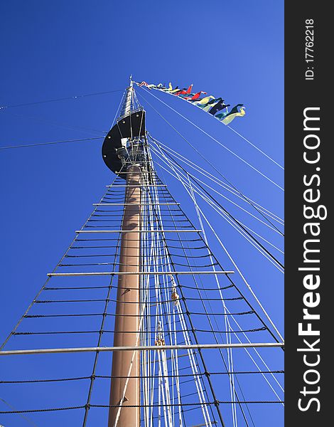 Looking up the mast of a tall ship agaoinst a deep blue sky