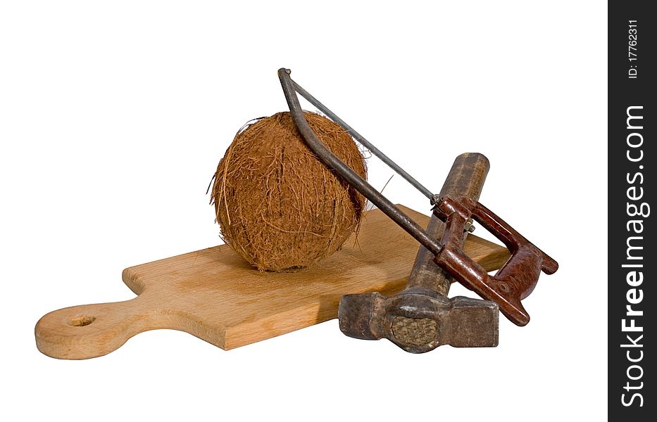 Coco a hacksaw and a hammer lying on a cutting board. Coco a hacksaw and a hammer lying on a cutting board.