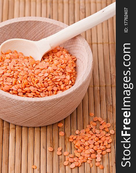 Red lentils in wooden bowl