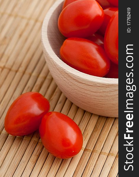 Cherry tomatoes in wooden bowl