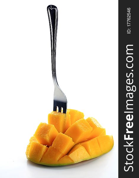 Fresh mango with fork isolated on a white background. Fresh mango with fork isolated on a white background