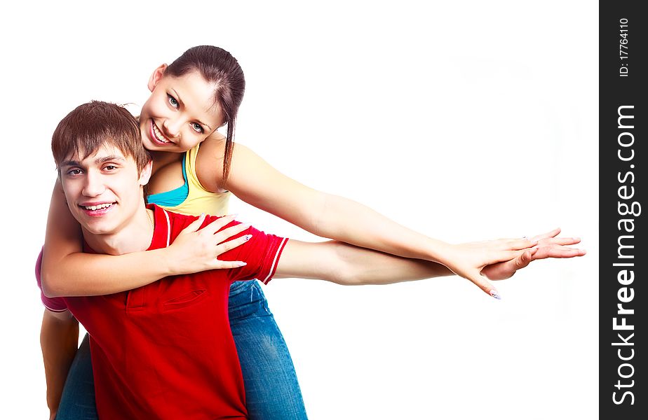 Happy excited teenage couple, a boy giving a piggyback ride to his girlfriend (focus on the boy)