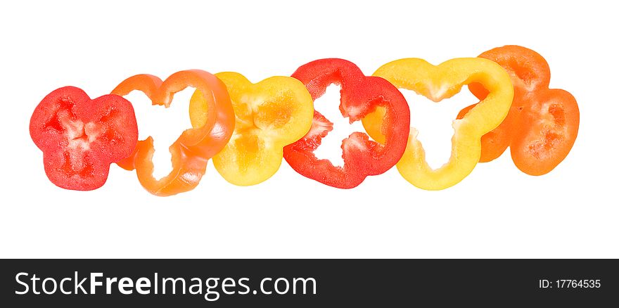 Pepper rings in yellow red orange colors on thw white background