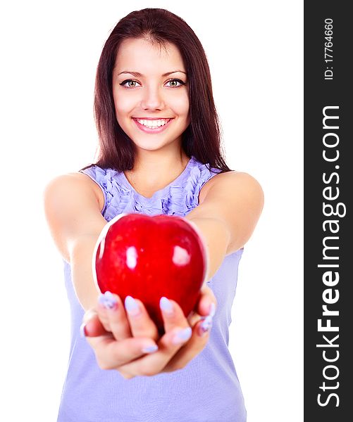 Beautiful young brunette woman giving us a big red apple (focus on the face). Beautiful young brunette woman giving us a big red apple (focus on the face)