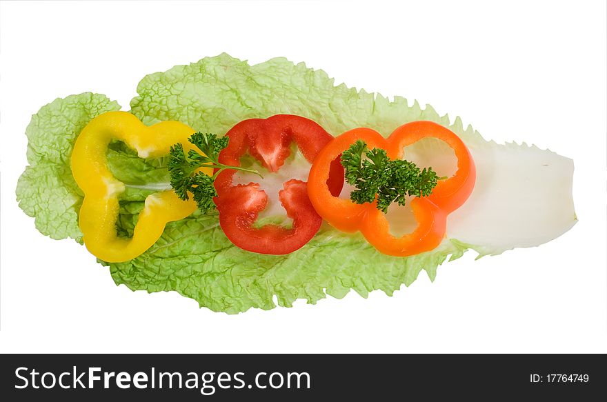 Color pepper rings with a green parsley on the chinese cabbage leaf