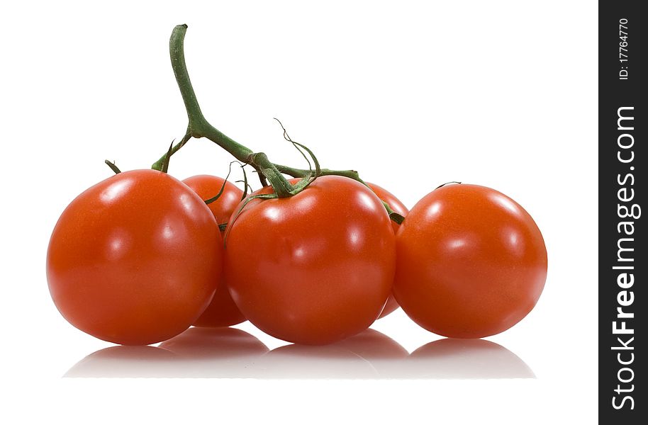 Five red tomatoes with a green stick on the white