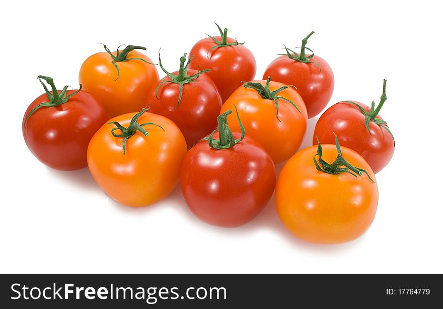 Yellow and red tomatoes in a group on the white background