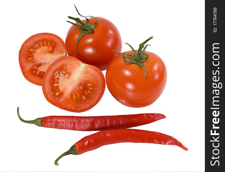 Red tomatoes with chilly peppers isolated on the white