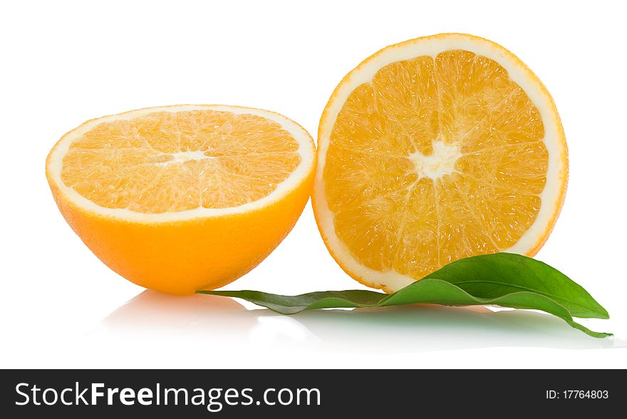 Two halfs of cropped orange with green leaves. Two halfs of cropped orange with green leaves