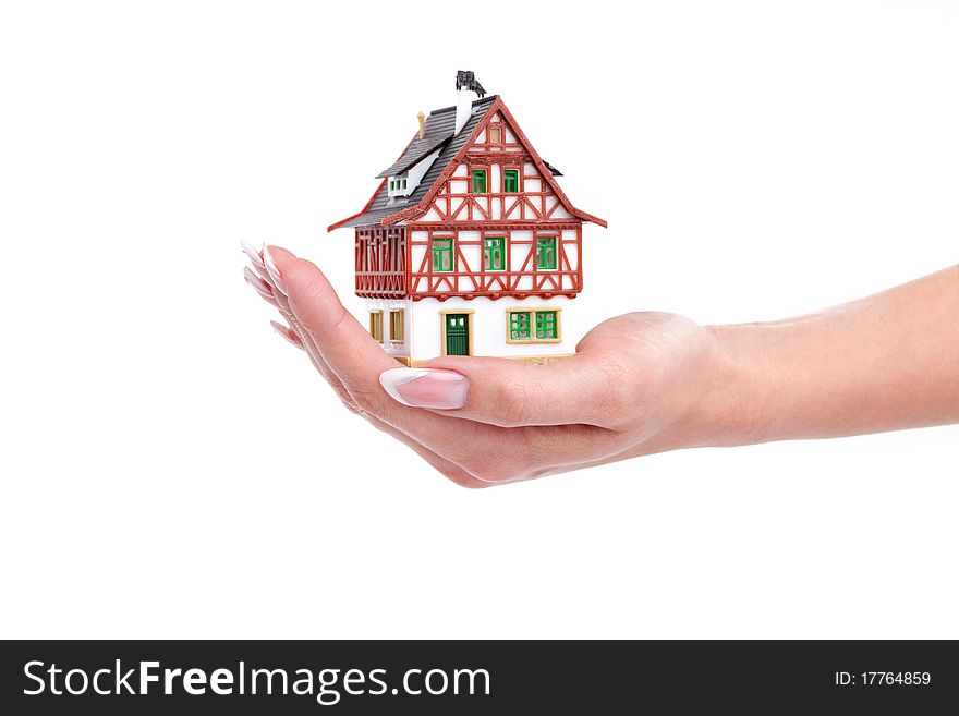 The house in woman hands on white