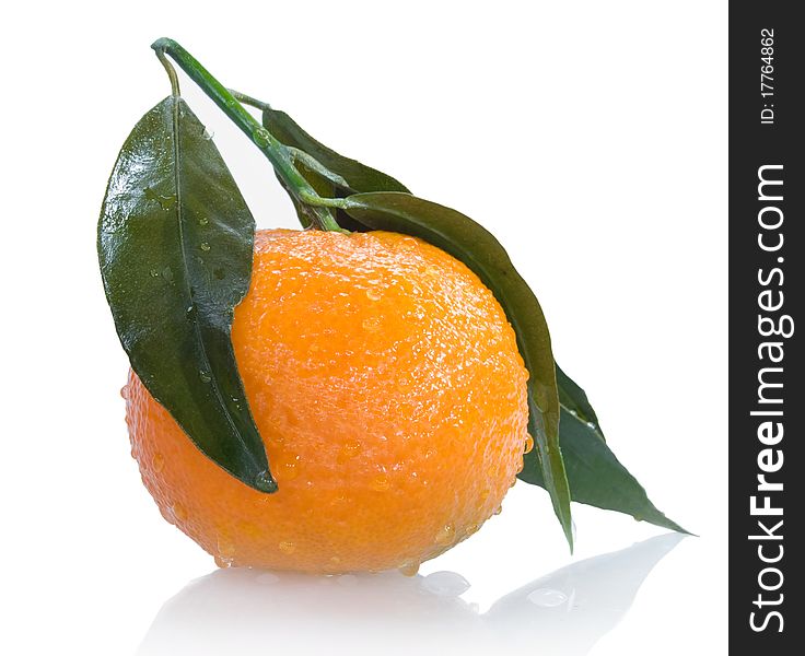 Ripe tangerine with leaves and drops of water