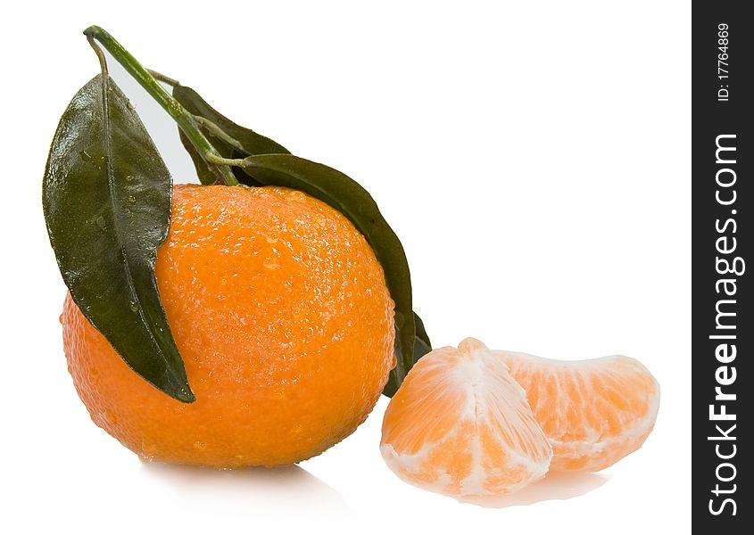 Fresh mandarin with drops of water and two segments