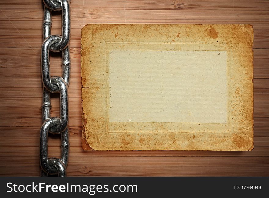 A old paper on wooden desks with chain as a background or texture on white