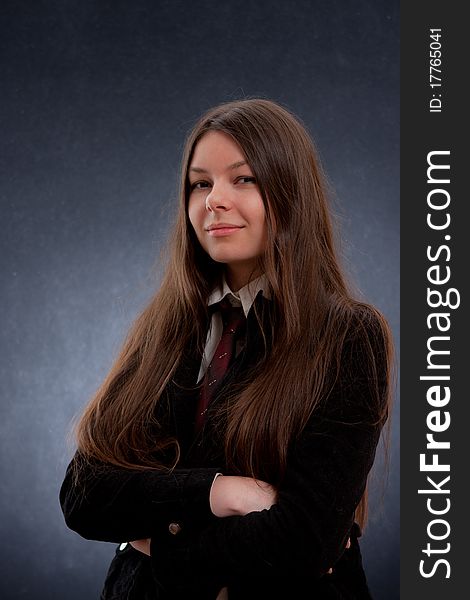 Charming young woman whith her arms crossed in a studio. Charming young woman whith her arms crossed in a studio