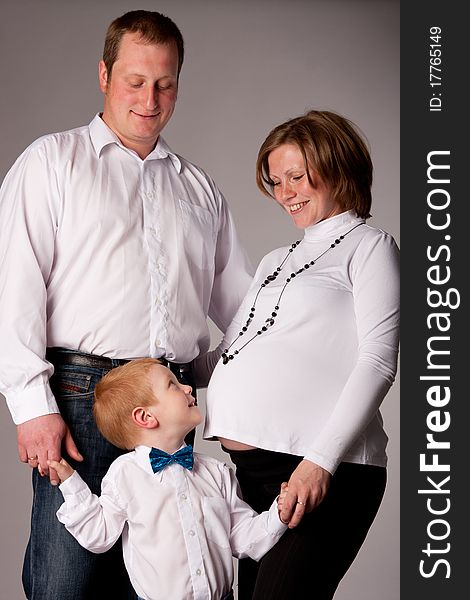 Beautiful couple with son in expectant of the second child. Beautiful couple with son in expectant of the second child