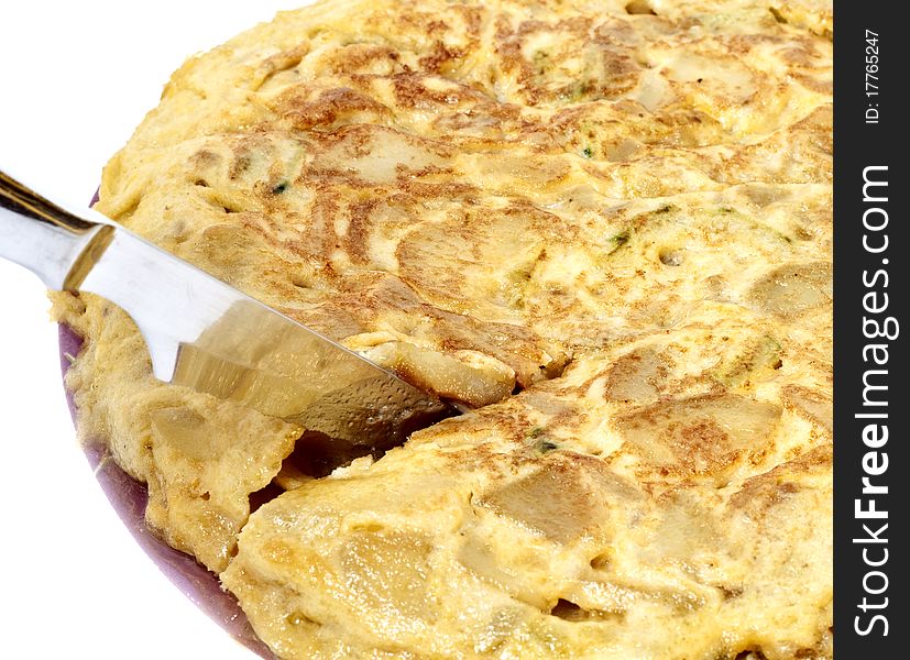 Cutting spanish omelet isolated in white