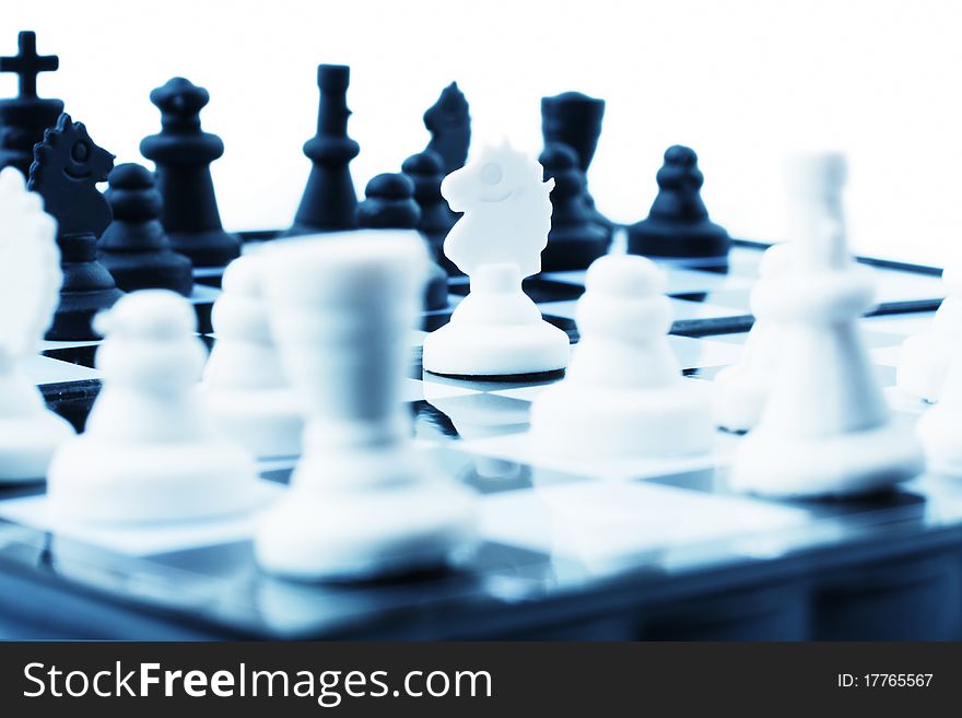 Composition with chessmen on a white background (selective focus)