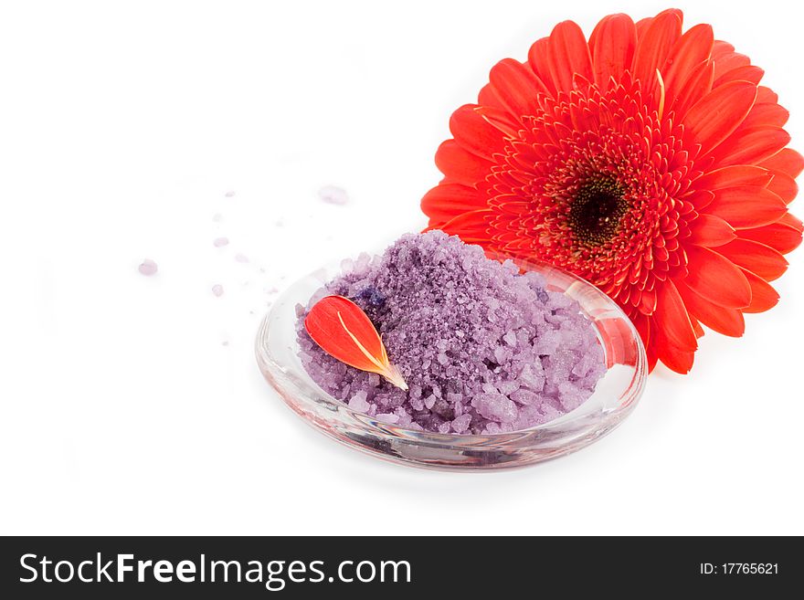 Sea salt with gerbera flowers and towels (selective focus)