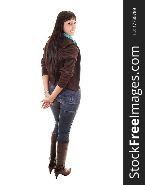 A beautiful woman standing with her back to the camera in jeans and a brown sweater and boots and long black hair, on white background. A beautiful woman standing with her back to the camera in jeans and a brown sweater and boots and long black hair, on white background.