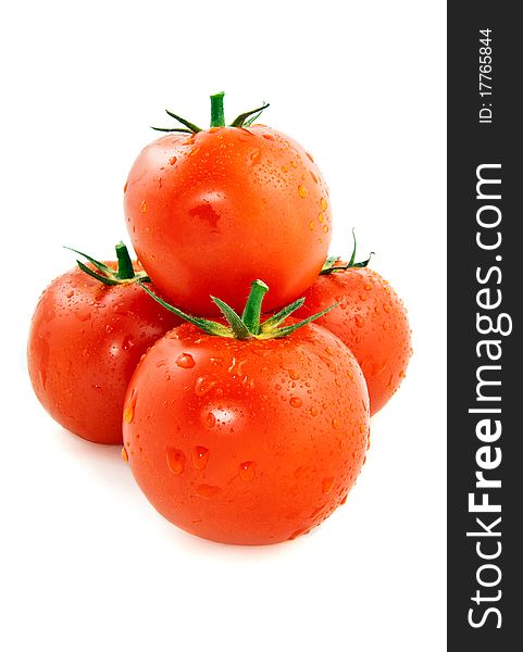 Pyramid of the four red and moist tomatoes on a white background. Pyramid of the four red and moist tomatoes on a white background