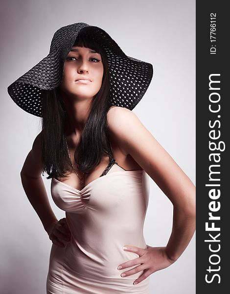 Beautiful young attractive woman posing in a hat