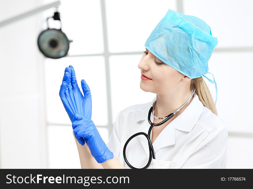 Young working beautiful woman doctor in uniform