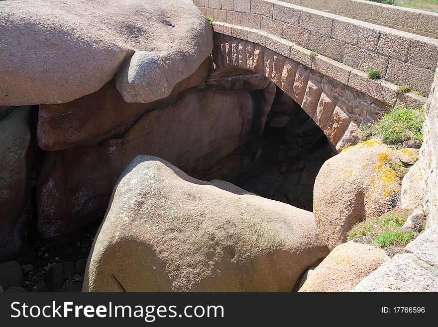 Massive stone bridge made from rose granite rocks