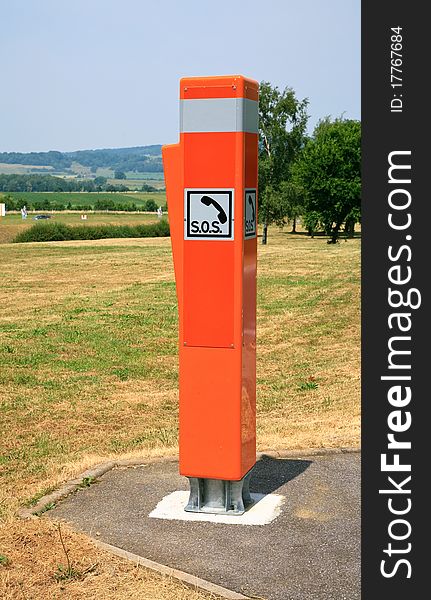 Bright orange lightreflecting traffic box SOS in France