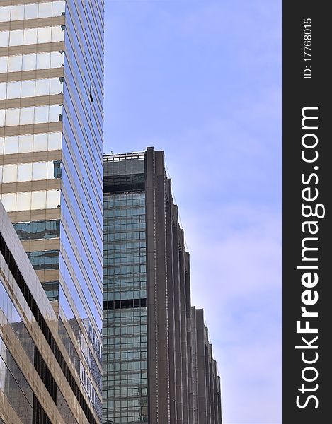 Modern buildings in Hongkong, under blue sky, with glass external and reflection, means business developing and urban environment. Modern buildings in Hongkong, under blue sky, with glass external and reflection, means business developing and urban environment.