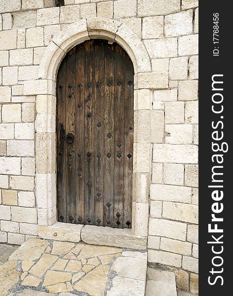 Brown door on the background of a white wall