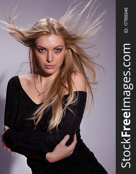 Young blonde woman on isolated studio background