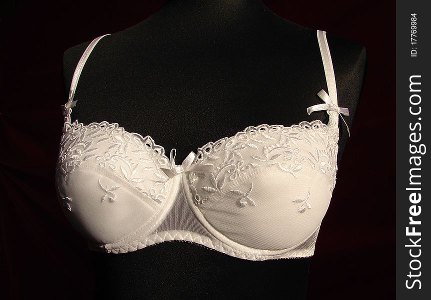 White, shiny bra, made in Poland, pictured in a shop. White, shiny bra, made in Poland, pictured in a shop.