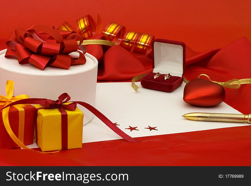 Box with a gift on a red fabric still life