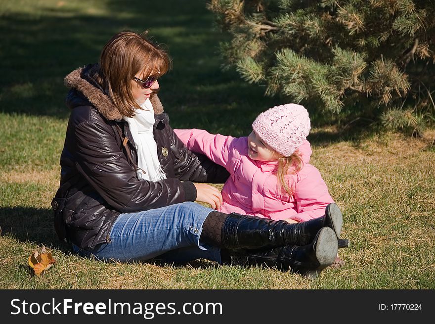 Mum with a daughter in autumn park outdoor