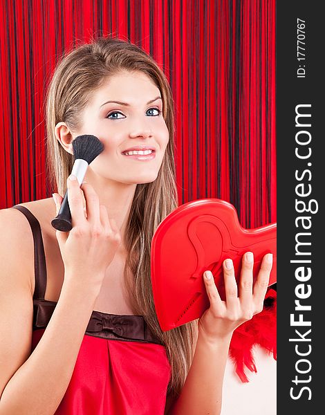 Young, beauty woman holding a red heart mirror. Young, beauty woman holding a red heart mirror