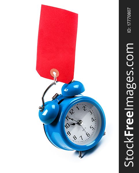 Old Fashioned blue mechanical alarm clock with a red luggage tag. Old Fashioned blue mechanical alarm clock with a red luggage tag