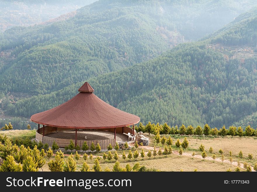 Arbor with a round roof mountains in the background