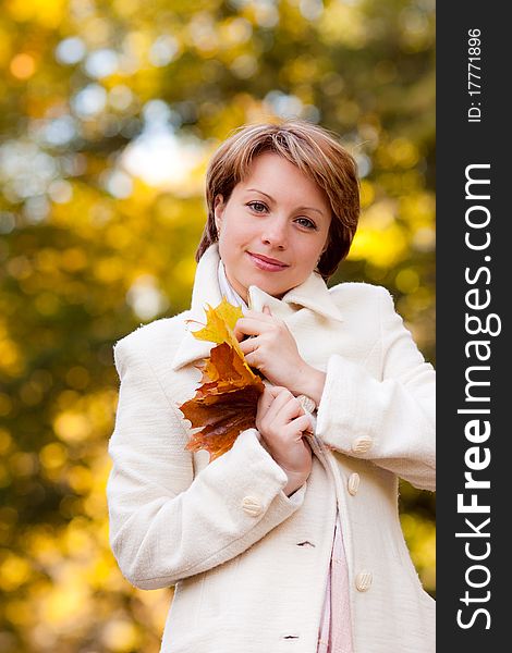 Charming Young Woman In An Autumn Park
