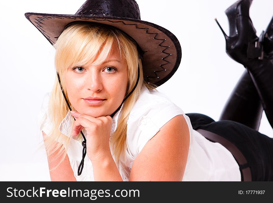 Charming young woman in cowboy hat on white background