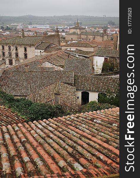 View of the lower town of the streets of Trujillo (Spain) with roof tops in the foreground. View of the lower town of the streets of Trujillo (Spain) with roof tops in the foreground