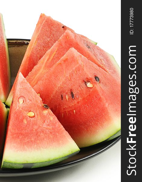 Cut watermelon on plate on white