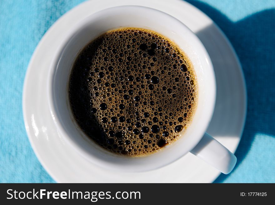 White cup of coffee on a blue background