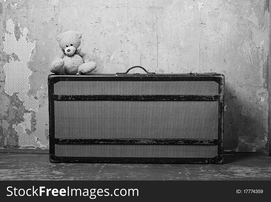 Old suitcase with Teddy