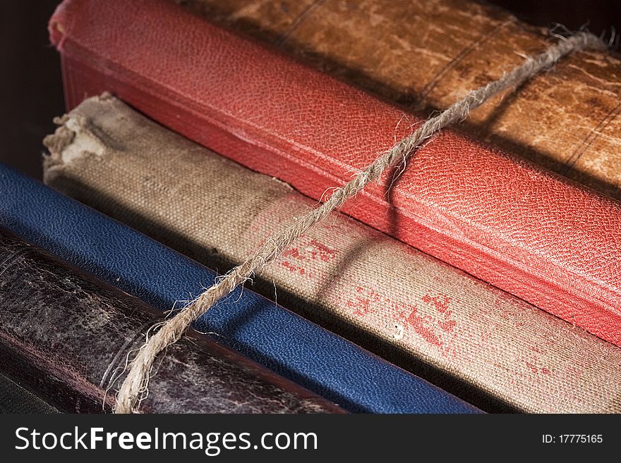 Archival books in a book-depository are tied up by a cord. Archival books in a book-depository are tied up by a cord.