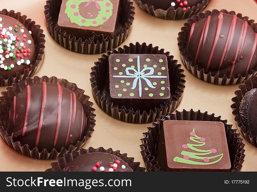 Set of chocolate candies with a decorative ornament.