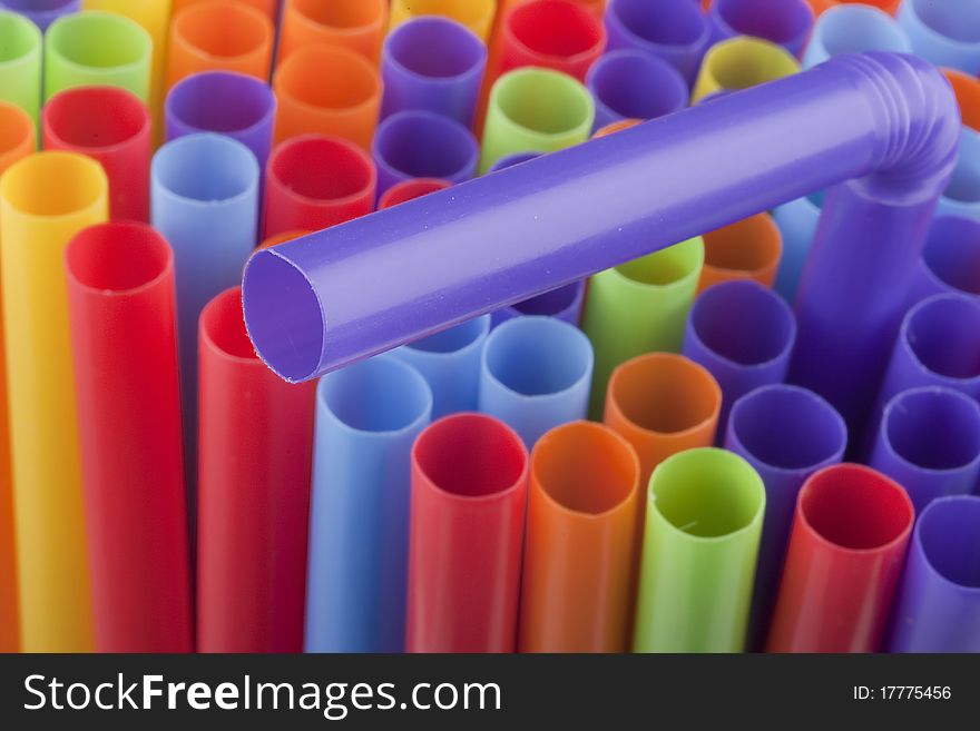 Plastic tubes of different colors in the background.