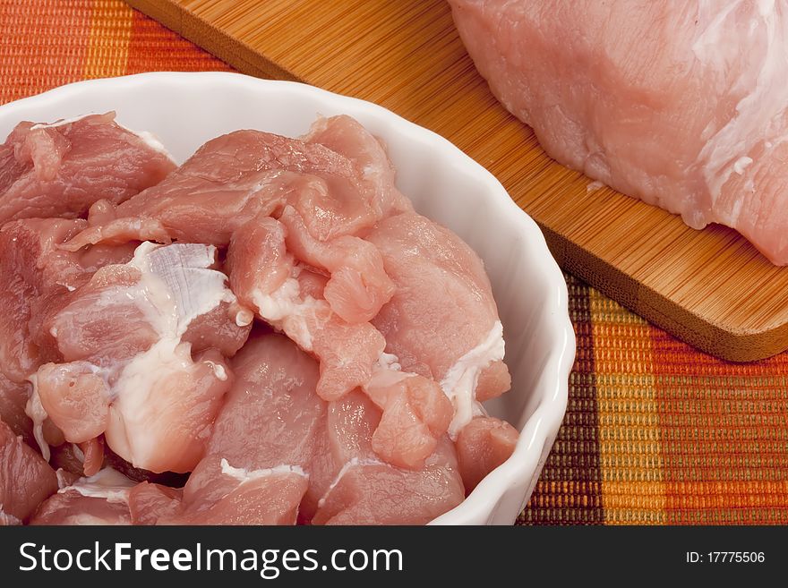 A piece of raw meat before cooking in the kitchen environment.