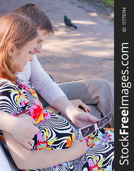 Young family in waiting for the child. A walk in the park