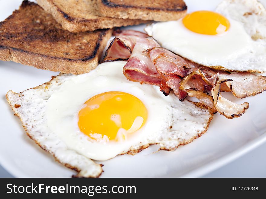 Breakfast - roasted toasts, eggs, bacon. Breakfast - roasted toasts, eggs, bacon