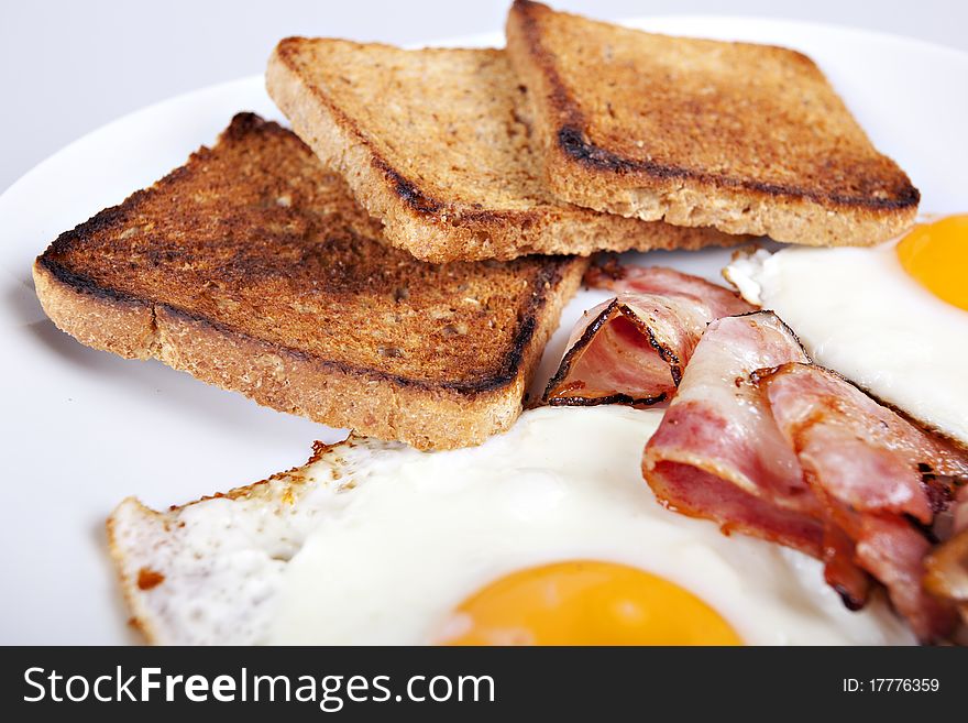 Breakfast - roasted toasts, eggs, bacon. Breakfast - roasted toasts, eggs, bacon